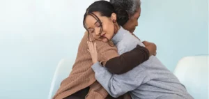 Two women hugging - understanding eczemas impact on mental health with Flexitol