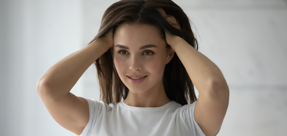 Young woman enjoying the benefits of a healthy scalp