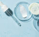 Promotional graphic on a light blue background with molecule chains and laboratory dishes with swashes of gel, cream and lotion