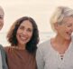 Four women smiling at the camera - going through the menopause and experiencing itchy, dry menopausal skin